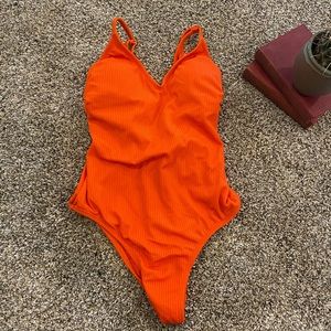 Never worn. Orange high cut swimsuit.
